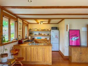 a kitchen with a sink and a refrigerator at Character Harbour Retreat in Dunedin +17 photos