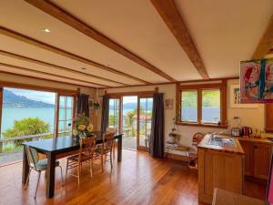 a kitchen and dining room with a table and chairs at Character Harbour Retreat in Dunedin