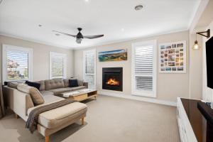 a living room with a couch and a fireplace at Resort Living on Tempest in Torquay