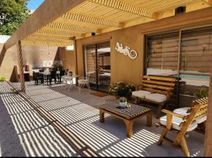 a patio with a table and chairs at Casa Balmaceda Paihuano in Paihuano