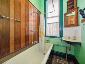 a bathroom with a bath tub and a sink at The Outlook in Leura +7 photos