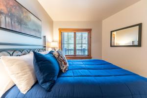 a bedroom with a blue bed and a window at Expedition Station 8598 in Keystone +35 photos