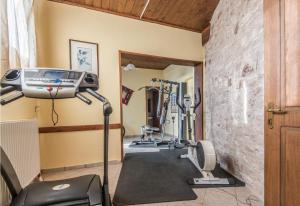 a gym with treadmills and machines in a room at To Aidoni in Karpenision
