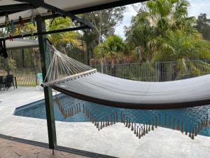 a hammock in front of a swimming pool at Bimbimbie retreat in Jeremadra
