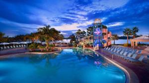 a pool at a resort with chairs and a hotel at Disney's Contemporary Resort in Orlando