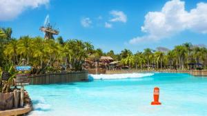 a large pool at a theme park with palm trees at Disney's Yacht Club Resort in Orlando