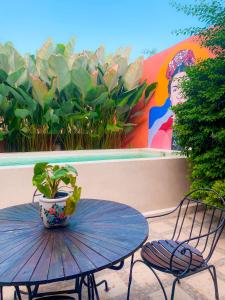 a table and chairs with a potted plant on a patio at Villa Amador by Suasana Villa in Jarakan +2 photos
