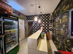 a restaurant with a soda machine in a store at Vila Rock Hostel - próximo Allianz Parque, Vila Madalena, Av Paulista, Hospital das Clínicas INCOR FMUSP in São Paulo +37 photos