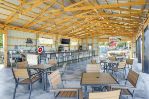 ein Restaurant mit Tischen und Stühlen und eine Bar in der Unterkunft Waterfront Port Clinton Cottage 5 Mi to Lake Erie in Port Clinton