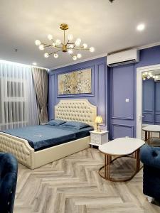 a bedroom with a bed and a blue wall at Homestay Ocean park Gia Lâm in Hanoi