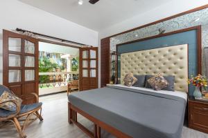 a bedroom with a large bed and a balcony at The Ultimate Staycation Goa - 10BHK in Calangute