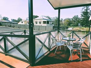a patio with a table and chairs on a balcony at Kilcoy Motel in Kilcoy