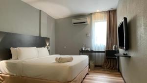 Postel nebo postele na pokoji v ubytování The Leverage Business Hotel - Rawang