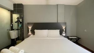 Postel nebo postele na pokoji v ubytování The Leverage Business Hotel - Rawang