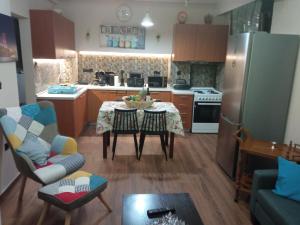 a small kitchen with a table and a refrigerator at GIANNIS House 2 in Kavála