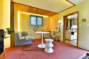 a room with a table and a table and chairs at ADO hotel in Seoul