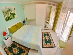 a bedroom with a bed in a room with rugs at Apartments Andrija in Kotor