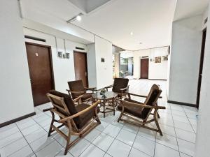 a dining room with chairs and a table at Casa Feby Guest House in Bandung