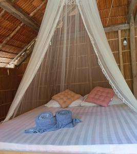 a bed in a tent with two towels on it at Pin Wawiyai Natural Homestay in Yennanas Besir