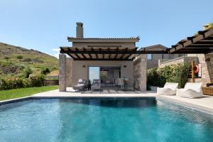 a swimming pool in the backyard of a house at Mont D' Olives in Mythimna