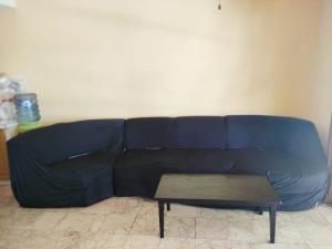 a blue couch with a coffee table in a room at Condominium Lippo Carita Selatan - Lantai Dasar in Carita