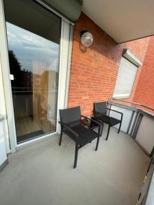 two chairs and a table on a balcony at Apartment - für Monteure und Familien in Salzgitter +4 photos