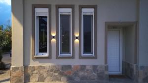 a building with three windows with lights on it at uRban Loft Living in Karditsa