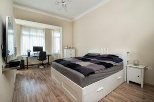 a bedroom with a bed and a desk with a computer at D17 Apartment in Budapest