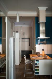 a kitchen with a refrigerator and a table with chairs at D17 Apartment in Budapest +13 photos