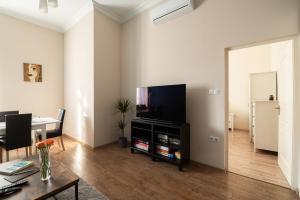 a living room with a flat screen tv and a table at D17 Apartment in Budapest