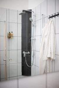 a bathroom with a shower with a white towel at D17 Apartment in Budapest