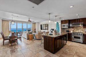 a kitchen and living room with a view of the ocean at Honua Kai Hokulani 825 in Lahaina