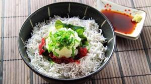 a bowl of rice with vegetables and sauce on a table at Hotel Route-Inn Susono Inter in Susono