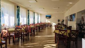 a row of tables and chairs in a restaurant at Hotel BIESZCZADski Wańkowa in Wańkowa