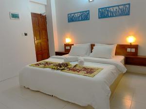 Postel nebo postele na pokoji v ubytování Paradise Retreat, Maafushi