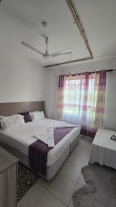 Postel nebo postele na pokoji v ubytování sunset paradise