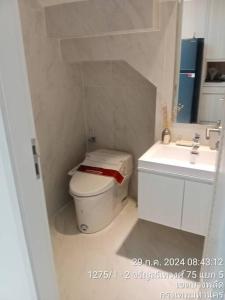 a white bathroom with a toilet and a sink at The Pearl Residence House-At least 2 months in Bang O +6 photos