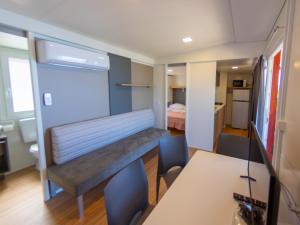 a room with a bench in the middle of a room at Adria Family Zone B 61 in Klenovica