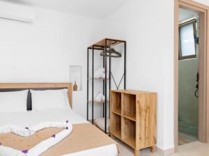 a bedroom with a bed and a room with a shower at VaStekaHouse in Haraki