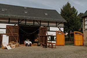 a large building with a table and chairs in it at Familienhof Waida in Dennheritz