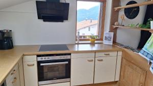 a kitchen with a stove and a counter top at Ferienwohnung Mayr in Füssen