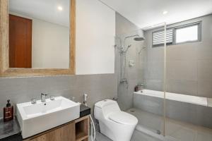 a bathroom with a sink and a toilet and a tub at Cove Villa Prana in Jimbaran +24 photos