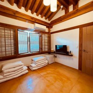 a living room with a bunch of towels on the floor at Jeonju Hanok village Deoksugung in Jeonju +45 photos