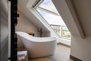 a bath tub in a bathroom with a window at Sandfield House in Whitby +40 photos