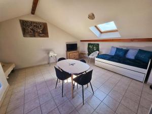 a living room with a couch and a table at Thonon plage terrasse et parking in Thonon-les-Bains