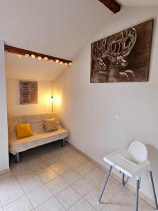 a room with a bed and a chair in it at Thonon plage terrasse et parking in Thonon-les-Bains