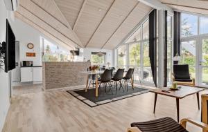 a kitchen and living room with a table and chairs at 3 Bedroom Amazing Home In Sydals in Skovmose