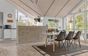 a kitchen and dining room with a table and chairs at 3 Bedroom Amazing Home In Sydals in Skovmose