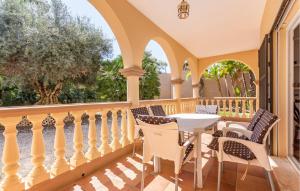 a patio with a table and chairs on a balcony at Beautiful Home In Alhaurin De La Torre in Alhaurín de la Torre +41 photos