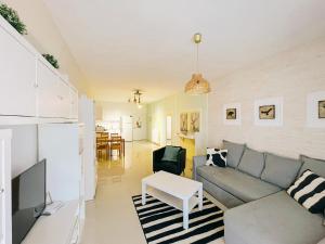 a living room with a couch and a table at Spacious & Modern 1 Bedroom Holiday Home in Perivolia tou Trikomou